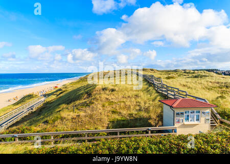 SYLT ISLAND, GERMANY - SEP 11, 2016: Coastal walkway along Wenningstedt beach in early morning light, Sylt island, North Sea, Germany. Stock Photo