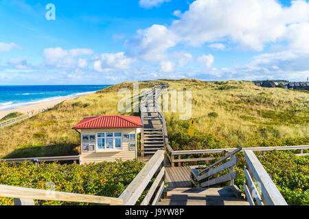 SYLT ISLAND, GERMANY - SEP 11, 2016: Coastal walkway along Wenningstedt beach in early morning light, Sylt island, North Sea, Germany. Stock Photo