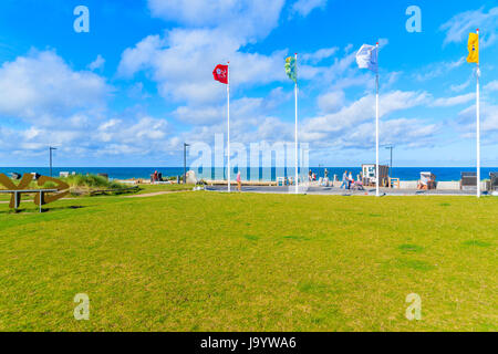 SYLT ISLAND, GERMANY - SEP 11, 2016: Green lawn and flags waviing on wind in Wenningstedt seaside village on Sylt island, North Sea, Germany. Stock Photo