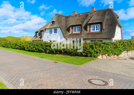 Typical Frisian house with thatched roof in Wenningstedt seaside village on Sylt island, North Sea, Germany Stock Photo