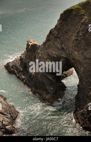 UK, Wales, Pembrokeshire, Solva, natural stone arch in cliffs below Coast Path Stock Photo