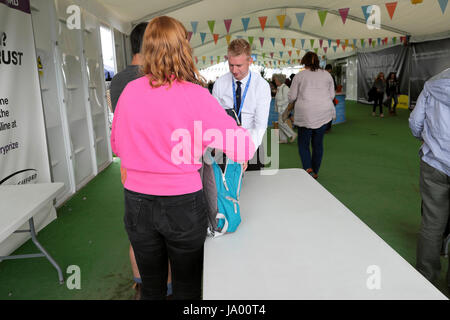 Security inspection of visitor bag at the marquee entrance of the 2017 Hay Festival, Hay-on-Wye, Wales UK    KATHY DEWITT Stock Photo