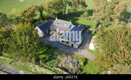 Aerial photograph taken from a Drone of a family house converted from an old farmers cottage in East Ayrshire, Scotland Stock Photo