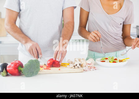Couple making a salad in the kitchen Stock Photo
