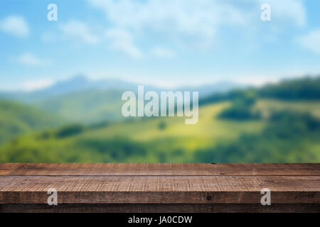 Empty wooden desk with free space for product presentation. Nature in background. Stock Photo