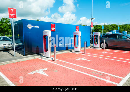 Electric car recharging point for Tesla electric cars at the British Eurotunnel terminal. Showing the Tesla name and logo. Stock Photo
