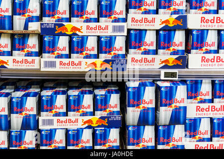 Cans of Red Bull Energy Drink for sale in a supermarket. Stock Photo