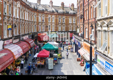 Local shops and market stalls in Electric Avenue in Brixton, South London. Stock Photo