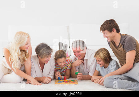 Family playing board games in sitting room Stock Photo
