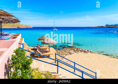 Steps from coastal bar to Cala Comte beach, Ibiza island, Spain Stock Photo