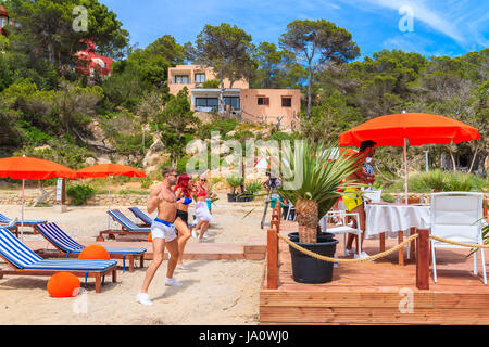 IBIZA ISLAND, SPAIN - MAY 17, 2017: Young people dancing on terrace of beach restaurant in Cala Carbo while they are being filmed in order to produce  Stock Photo