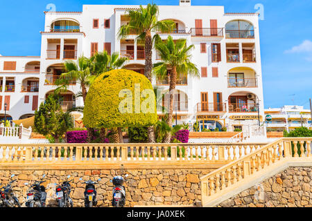 SANTA EULARIA TOWN, IBIZA ISLAND - MAY 21, 2017: view of luxury hotel building built in traditional colonial Spanish style and scooters paring in fron Stock Photo