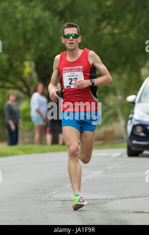 Quenington, UK - JUNE 4, 2017: Lead runner passes through the village of Quenington, Gloucestershire in the Fairford 10K run Credit: urbanbuzz/Alamy Live News Stock Photo