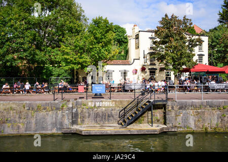 Bristol, England - July 17, 2016: Crowds and customers line the quayside of Bristol's Floating Harbour outside the Ostrich pub. Stock Photo