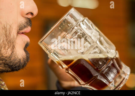 Man drinking a dark beer, delicious craft beer Booze Brew Alcohol Celebrate Stock Photo