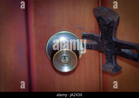 Close up of a burglar holding a crowbar to open a housedoor Stock Photo