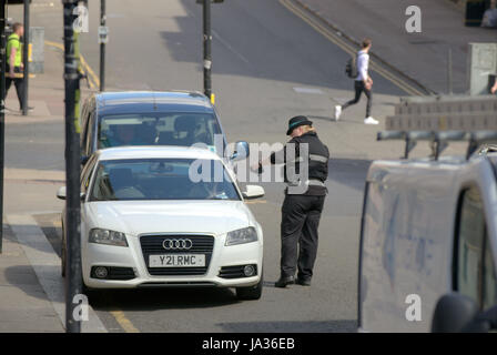traffic warden issuing ticket on Hope street Stock Photo