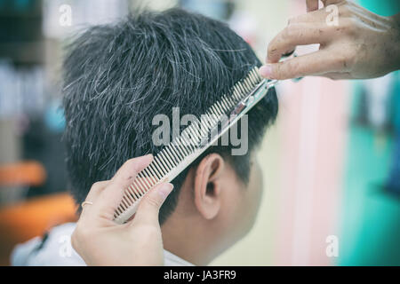 a man cutting hair  at barber Stock Photo