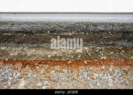 construction of black asphalt layer road with soil and stone Stock Photo