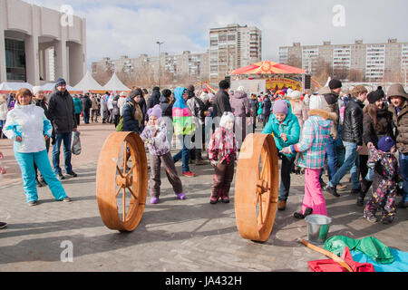 PERM, RUSSIA - March 13, 2016: Children ride the big wheel at the celebration of Carnival Stock Photo