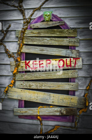 Keep Out - Old grungy wood wall with the words "Keep Out" in red on window background Stock Photo