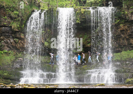 People,hiking,walk,behind,beneath,waterfall,Sgwd yr Eira,Waterfall of the Snow,Afon Heptse,river,Powys,Brecon Beacons,National,Park,Wales,Welsh,U.K,UK Stock Photo