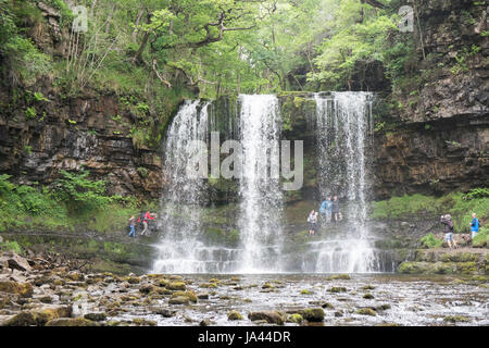 People,hiking,walk,behind,beneath,waterfall,Sgwd yr Eira,Waterfall of the Snow,Afon Heptse,river,Powys,Brecon Beacons,National,Park,Wales,Welsh,U.K,UK Stock Photo