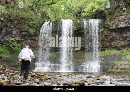 People,hiking,walk,behind,beneath,waterfall,Sgwd yr Eira,Waterfall of the Snow,Afon Heptse,river,Powys,Brecon Beacons,National,Park,Wales,Welsh,U.K,UK Stock Photo