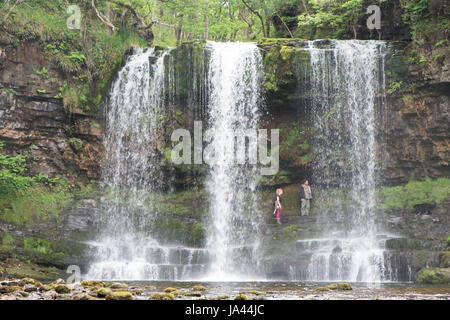 People,hiking,walk,behind,beneath,waterfall,Sgwd yr Eira,Waterfall of the Snow,Afon Heptse,river,Powys,Brecon Beacons,National,Park,Wales,Welsh,U.K,UK Stock Photo