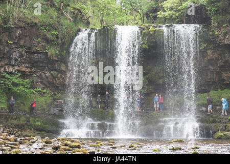 People,hiking,walk,behind,beneath,waterfall,Sgwd yr Eira,Waterfall of the Snow,Afon Heptse,river,Powys,Brecon Beacons,National,Park,Wales,Welsh,U.K,UK Stock Photo