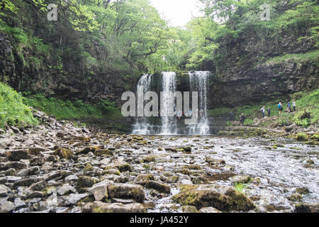 People,hiking,walk,behind,beneath,waterfall,Sgwd yr Eira,Waterfall of the Snow,Afon Heptse,river,Powys,Brecon Beacons,National,Park,Wales,Welsh,U.K,UK Stock Photo