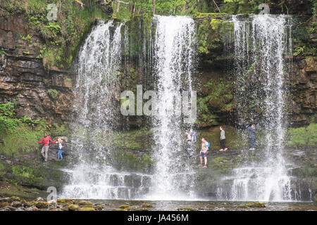 People,hiking,walk,behind,beneath,waterfall,Sgwd yr Eira,Waterfall of the Snow,Afon Heptse,river,Powys,Brecon Beacons,National,Park,Wales,Welsh,U.K,UK Stock Photo