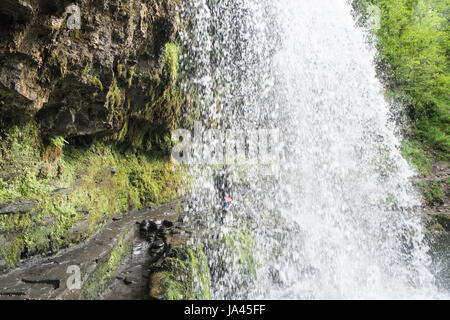 People,hiking,walk,behind,beneath,waterfall,Sgwd yr Eira,Waterfall of the Snow,Afon Heptse,river,Powys,Brecon Beacons,National,Park,Wales,Welsh,U.K,UK Stock Photo