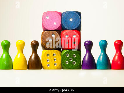 Multicolored wooden game dices with six numbers and pawns Stock Photo