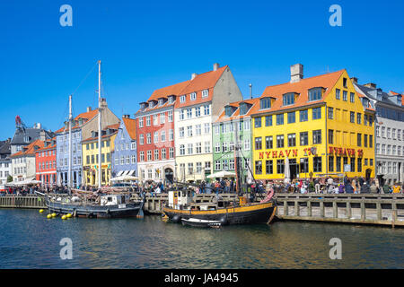 Copenhagen, Denmark - May 1, 2017: Nyhavn is a 17th-century waterfront, canal and entertainment district in Copenhagen, Denmark. Stock Photo