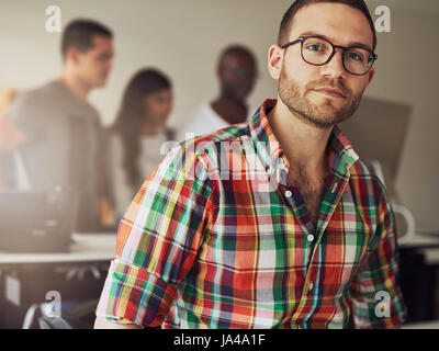 Modern businessman wearing casual clothes and glasses in the office. Stock Photo