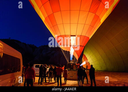 Goreme, Turkey - October 16, 2016: Morning start of Hot air balloons flying over Cappadocia. Preparation balloon for flight. Nevsehir Province Stock Photo