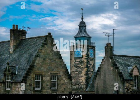 Historic old buildings in old town, Stirling, Scotland, UK, with Tolbooth tower clock and stepped gable roofs against blue sky Stock Photo