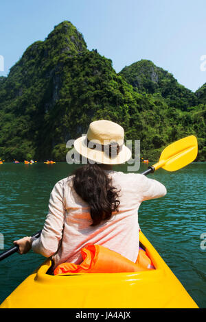 Girl kayaking on the seaside of Halong bay in Vietnam Stock Photo