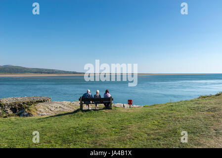 Family sat overlooking the estuary at Borth-y-Gest near Porthmaodg in North Wales. Stock Photo