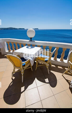 CALA FORNELLS, MALLORCA, SPAIN - SEPTEMBER 6, 2016: Table and ocean view at Tortuga Restaurant on a sunny day on September 6, 2016 in Cala Fornells, M Stock Photo