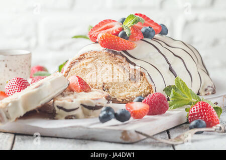 Fresh sweet braided bread in white chocolate with fresh berries Stock Photo