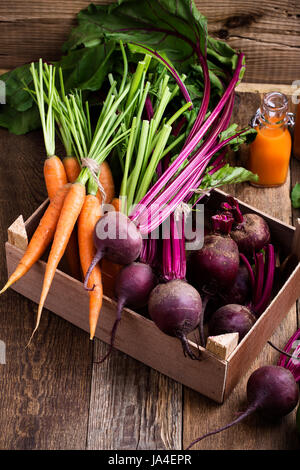 Organic  farm. Fresh vegetables in crate,   beetroots and  carrots on rustic wooden background Stock Photo