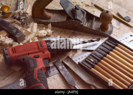 Various tools for carpentry on the table. Screwdriver, ruler, chisel on a wooden surface. Stock Photo