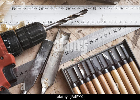 Various tools for carpentry on the table. Screwdriver, ruler, chisel on a wooden surface. Stock Photo