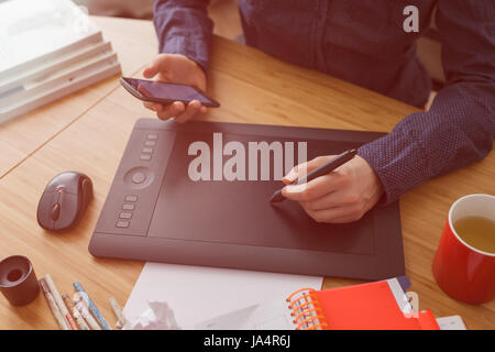 Workplace of designer. Illustrator draws a sketch Stock Photo
