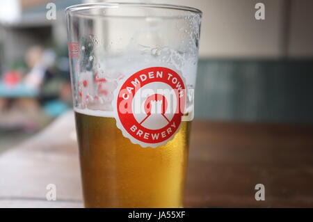 A pint glass with the logo of the Camden Town Brewery on it at a pub in Oxford, England, United Kingdom. June 2, 2017. Stock Photo