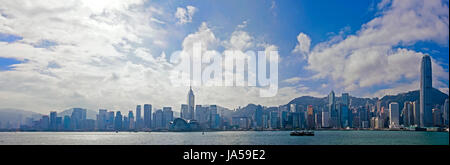 Horizontal panoramic (3 picture stitch) of the dramatic Hong Kong skyline on a sunny day.