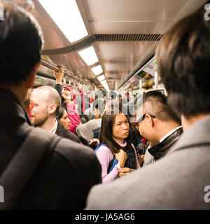 Square view of passengers inside the MTR, mass transit railway, in Hong Kong, China. Stock Photo