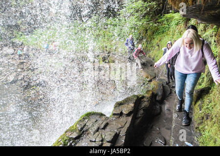 People,hiking,walk,behind,beneath,waterfall,Sgwd yr Eira,Waterfall of the Snow,Afon Heptse,river,Powys,Brecon Beacons,National,Park,Wales,Welsh,U.K,UK Stock Photo